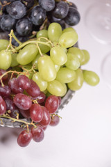 Blue, red and white grapes on the table. View with copy space