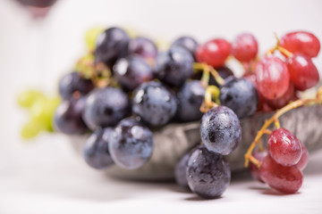 Blue, red and white grapes on the table. View with copy space