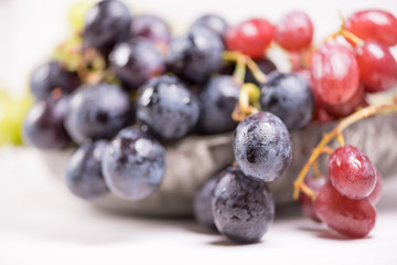 Blue, red and white grapes on the table. View with copy space