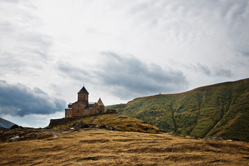 Gergeti christian church near Kazbegi, Stepancminda village in Georgia, Caucasus.