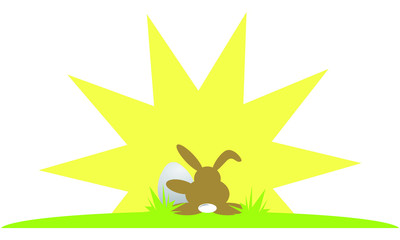 Osterhase sitzt mit seinem Ei auf grünem Gras und  sieht in die Sonne