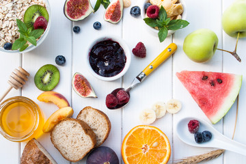 Flat lay healthy breakfast with fruits, oatmeal and honey