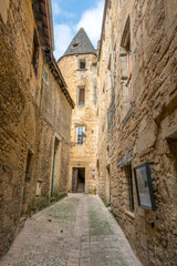 Small middle-age street with tower in Sarlat, Dordogne, Perigord Vert