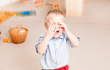 crying little boy in the kindergarten