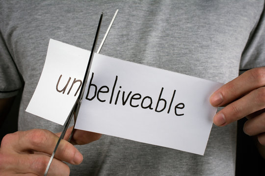 unbeliveable is beliveable concept. cutting card with the word unbelievable