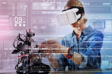 Very convenient. Calm attentive careful engineer wearing amazing virtual reality glasses and gently...