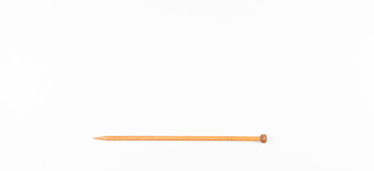 Wooden knitting needle on white background.