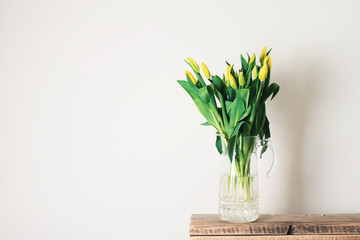 Bouquet of tulips in vase over white background