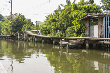 Fototapeta na wymiar Walkway near canal in Bangkok - view from Boat