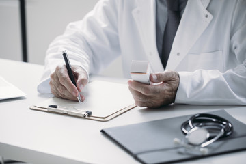 A Doctor Writing at His Office