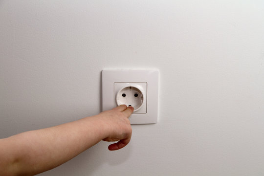 electrical security for safety home of ac power outlet for babies, baby hands playing with electric plug