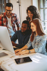 Young group of designers negotiates about design
