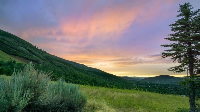 Cinemagraph of sunset clouds in a endless and seemless time lapse over a mountain meadow