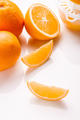 oranges and juice on a white background