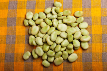 fresh broad beans on a rustic background