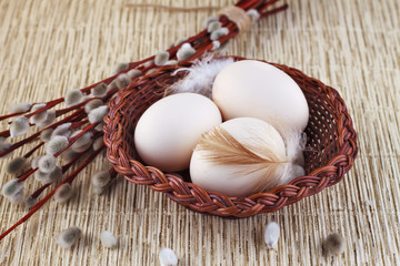 Easter eggs in a basket and willow.