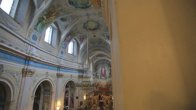 Beautiful interior of the Catholic Church with frescoes, mosaics, stucco, crystal