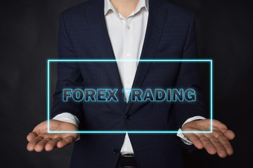 A businessman shows an inscription:FOREX TRADING