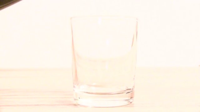 pour cola into a glass