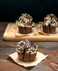 chocolate muffin sprinkled with nuts
