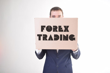 The businessman is holding a box with the inscription:FOREX TRADING