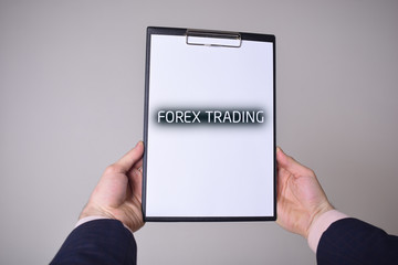 A businessman shows an inscription:FOREX TRADING