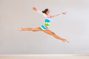 Fototapeta na wymiar Flying gymnast woman