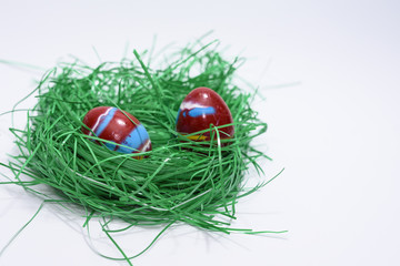 Easter eggs in wooden prams on green grass