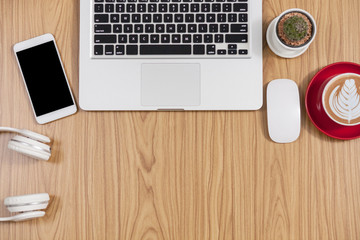 Office desk table with laptop,smartphone and coffee cup and accessories. Business desk with a keyboard, mouse and pen on white table. Top view of workplace