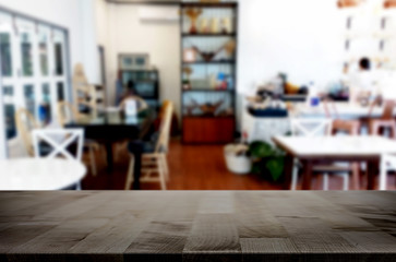 Selected focus empty brown wooden table and Coffee shop or restaurant blur background with bokeh image. for your photomontage or product display.