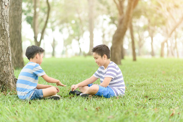 Fototapeta premium Two boy sit and play together