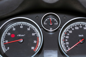 Fototapeta premium Modern car dashboard to help the driver. Tachometer, speedometer and fuel level sensor with illuminated pointer and number for ease control car in way. Transport technologies in mechanical engineering