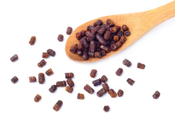 Granules of bee bread in a wooden spoon are isolated on a white background. Apitherapy. Beekeeping...