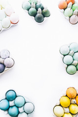 Happy easter! conceptual photo with a white background and sets of eggs colored using natural...