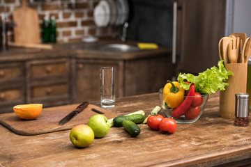 Obraz na płótnie Canvas fresh organic fruits and vegetables on wooden kitchen table