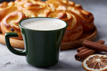 Homemade rose bread, cup of coffee, anise and cinnamon on white textured background, close-up, shallow depth of field