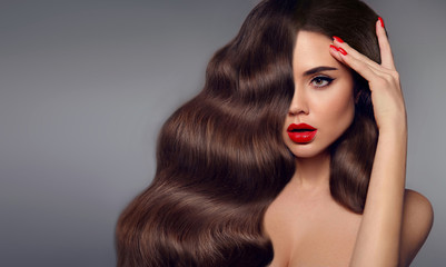 Beauty hair girl portrait. Red lips makeup, manicure nails and healthy wavy hairstyle. Sexy...