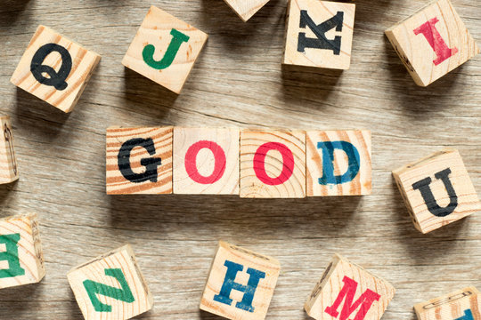 Letter block in word good with another on wood background