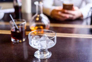 Restaurant table with ice cubes in glass