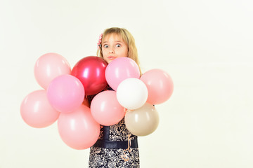 Beauty and fashion, punchy pastels. Little girl with hairstyle hold balloons. Birthday, happiness, childhood, look. Kid with balloons, birthday. Small girl child with party balloons, celebration.