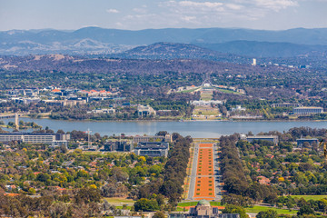 View of Canberra  from Mount Ainslie lookout - ANZAC Parade, Parliament House and modern architecture with mountains in background. ACT, Australia - obrazy, fototapety, plakaty