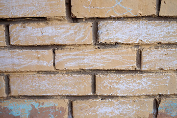 Texture of a beige brick wall with white spots