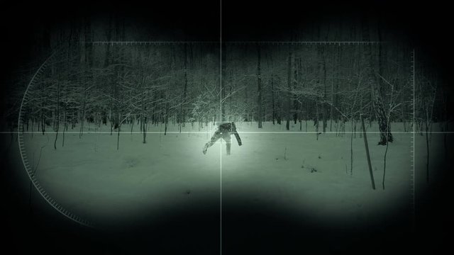 Night vision showing running man in a forest.