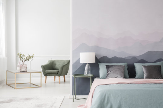 Large bed by landscape wallpaper
