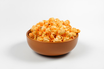 Brown deep plated filled with fresh salty popcorn