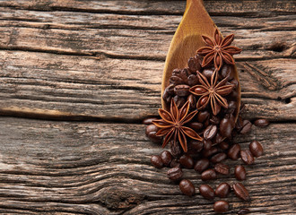 Coffee, anise  on wooden background.