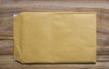 yellow envelope on a wooden table