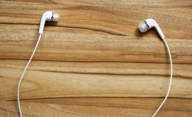 white headphones on a wooden table