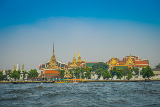 Outdoor view of Wat Pho or Wat Phra Chetuphon, 'Wat' means temple in Thai located in the horzont. The temple is one of Bangkok's most famous tourist sites in Thailand