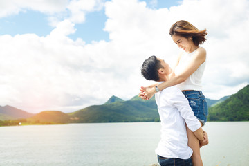 Women lovers are carry body on under blue sky and smile with the best moment between travel.
